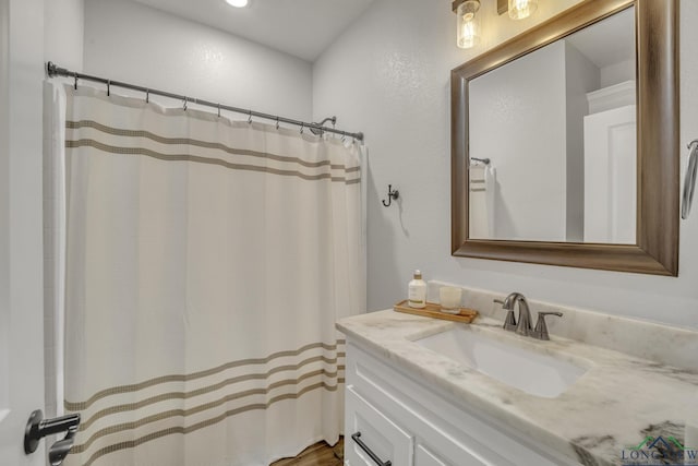 bathroom featuring a shower with shower curtain and vanity