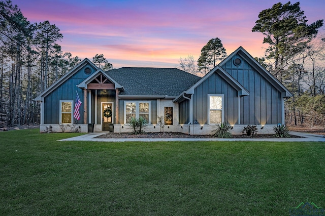 modern farmhouse style home featuring a yard