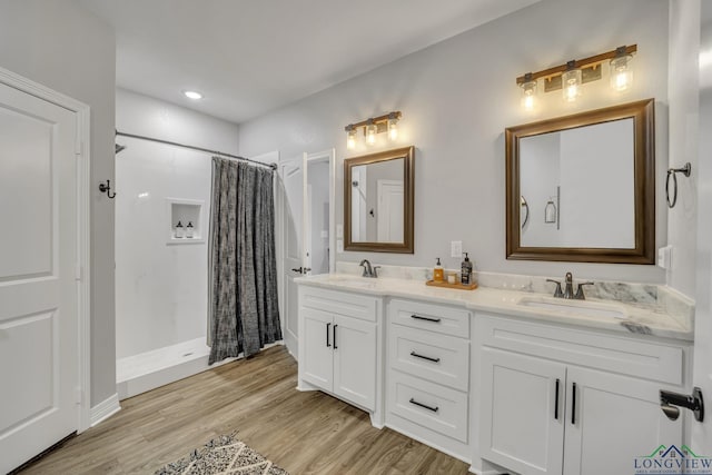 bathroom with hardwood / wood-style floors, vanity, and a shower with curtain