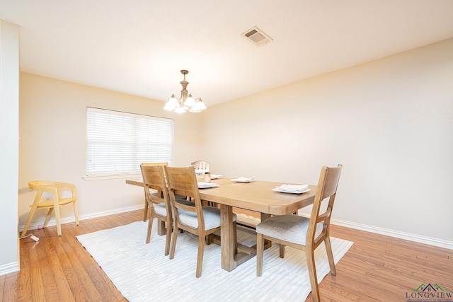 dining space featuring a chandelier and light hardwood / wood-style floors