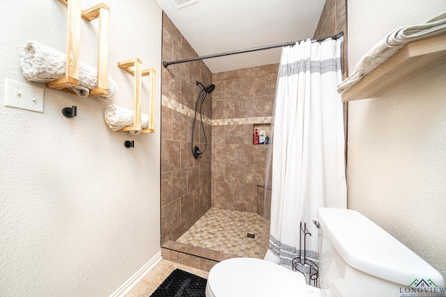 bathroom with curtained shower and toilet