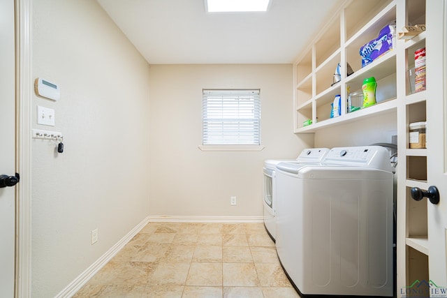 laundry room with light tile patterned flooring and separate washer and dryer