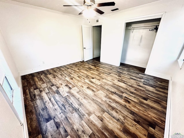 unfurnished bedroom with hardwood / wood-style flooring, ceiling fan, crown molding, and a closet