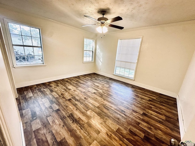 unfurnished room with ceiling fan, dark hardwood / wood-style flooring, a textured ceiling, and ornamental molding