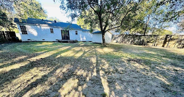 rear view of house featuring a lawn