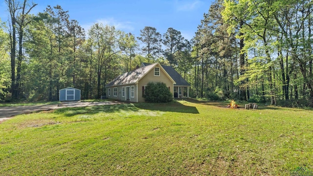 128 Inwood Rd, Texarkana, TX 75501 - view of yard with a view of trees, an outdoor structure, and a storage unit