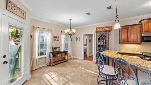 128 Inwood Rd, Texarkana, TX 75501 - kitchen featuring stainless steel appliances, visible vents, backsplash, and light stone counters