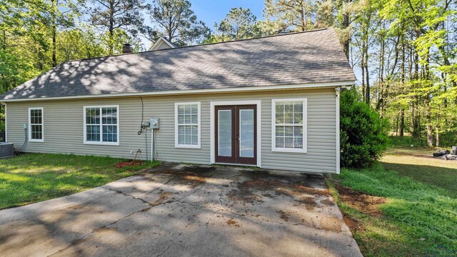 128 Inwood Rd, Texarkana, TX 75501 - view of front of house with concrete driveway, a front yard, roof with shingles, and french doors