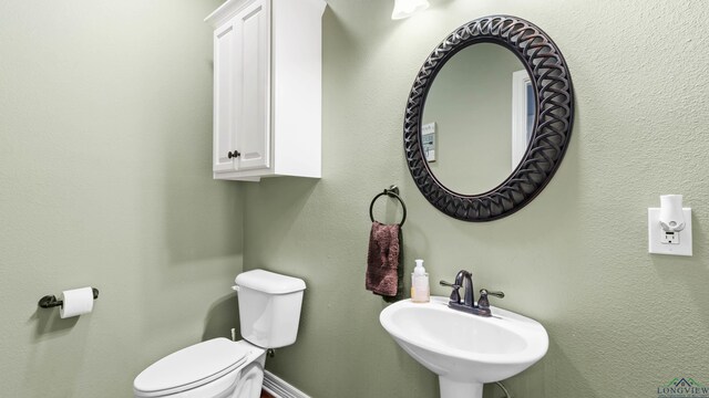 128 Inwood Rd, Texarkana, TX 75501 - half bath with baseboards, a sink, and toilet