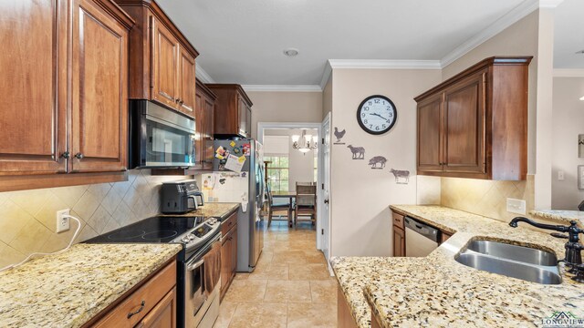 128 Inwood Rd, Texarkana, TX 75501 - kitchen with crown molding, appliances with stainless steel finishes, a sink, and light stone countertops