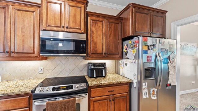 128 Inwood Rd, Texarkana, TX 75501 - kitchen with ornamental molding, backsplash, light stone counters, and stainless steel appliances