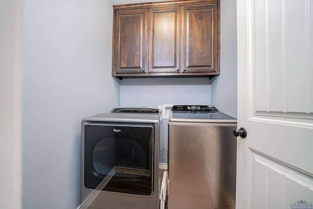 laundry area with cabinets and washing machine and clothes dryer