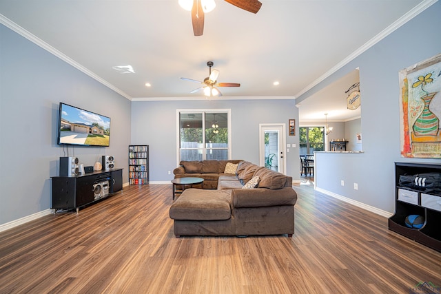 living room featuring crown molding, ceiling fan with notable chandelier, and hardwood / wood-style flooring