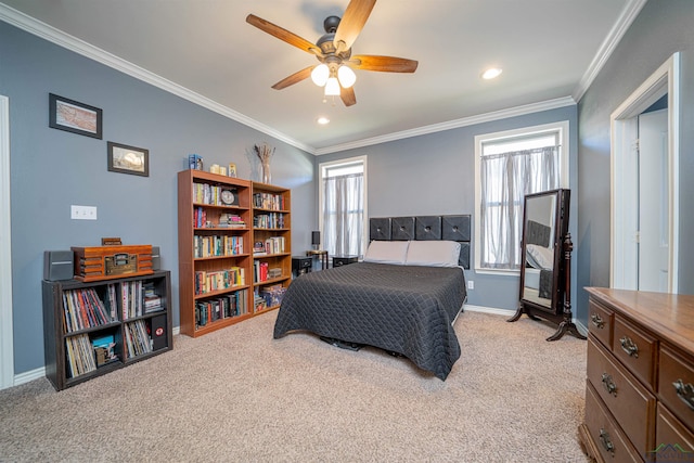 bedroom featuring ceiling fan, crown molding, and light carpet