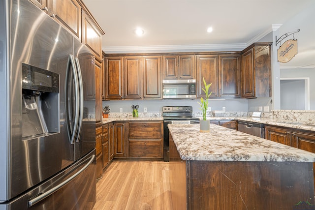 kitchen with light stone counters, crown molding, light wood-type flooring, and stainless steel appliances