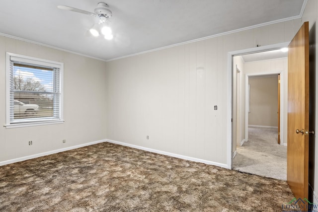 spare room with baseboards, ceiling fan, crown molding, and carpet flooring