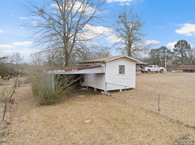 view of home's exterior featuring fence