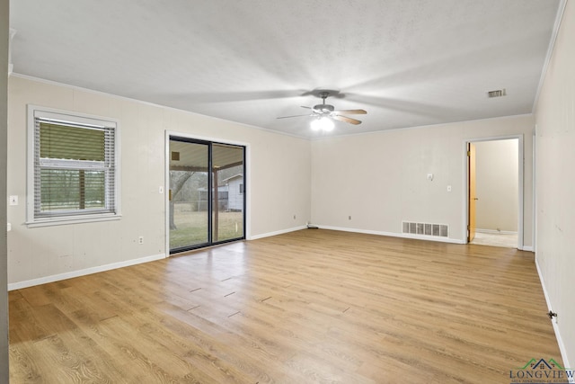 spare room with visible vents, ceiling fan, and a healthy amount of sunlight