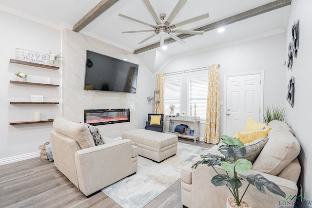 living room featuring baseboards, beamed ceiling, crown molding, light wood-style floors, and a fireplace