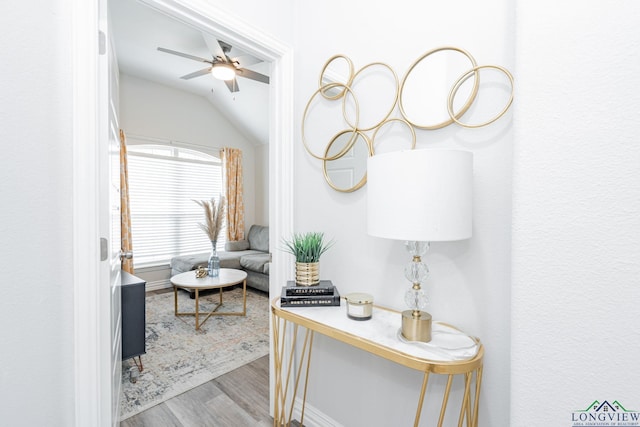 interior space featuring lofted ceiling, ceiling fan, and wood finished floors