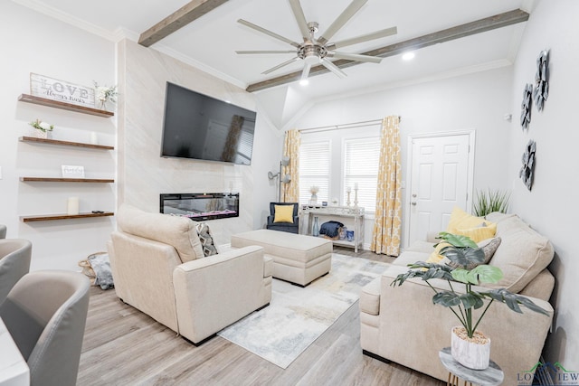 living room with beamed ceiling, a fireplace, wood finished floors, and crown molding