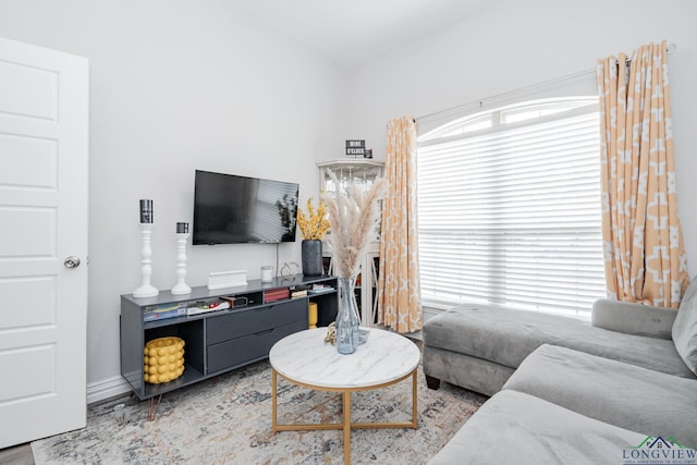 living area featuring baseboards