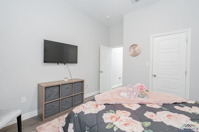 bedroom featuring baseboards and wood finished floors