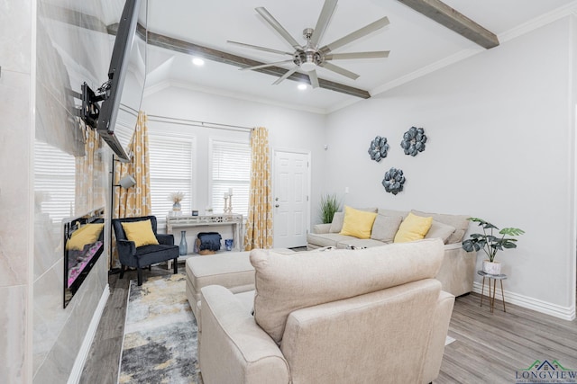 living area with lofted ceiling with beams, ornamental molding, wood finished floors, and baseboards