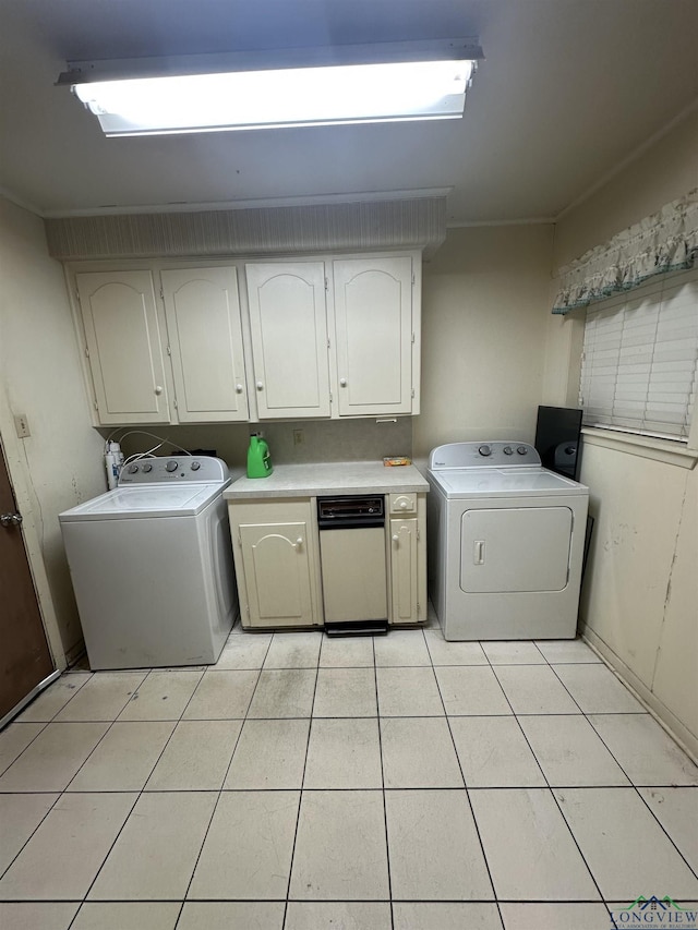 washroom featuring cabinets, light tile patterned floors, and separate washer and dryer