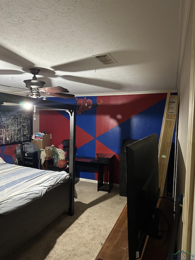 carpeted bedroom with ceiling fan and a textured ceiling