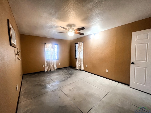 spare room with ceiling fan and a textured ceiling