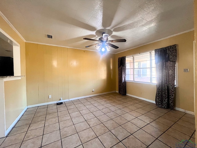 empty room featuring crown molding, ceiling fan, and light tile patterned floors