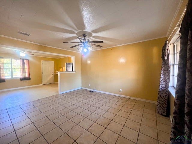 spare room with ornamental molding, ceiling fan, and light tile patterned flooring