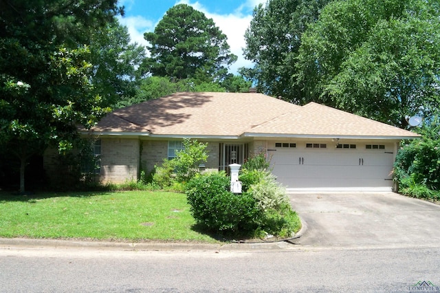 111 E Sycamore Ln, Longview, TX 75604 - single story home with an attached garage, a front lawn, driveway, a shingled roof, and brick siding