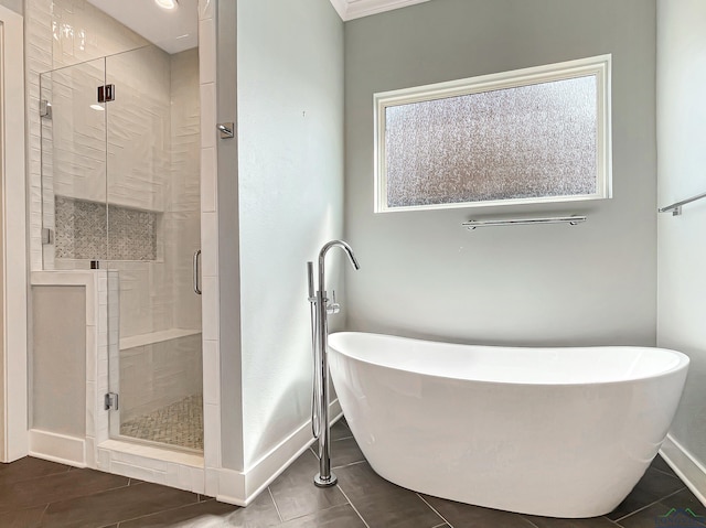 7323 Lake Pointe Cv, Tyler, TX 75703 - bathroom with baseboards, a freestanding bath, a shower stall, and ornamental molding