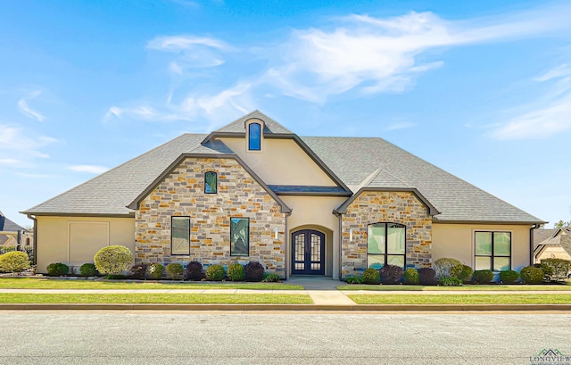 7323 Lake Pointe Cv, Tyler, TX 75703 - french country style house with french doors, stucco siding, roof with shingles, and stone siding