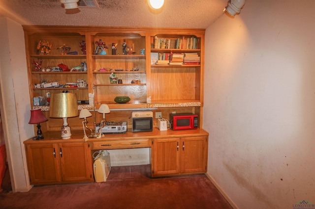 1006 Quitman St, Pittsburg, TX 75686 - office with built in study area, a textured ceiling, and dark colored carpet