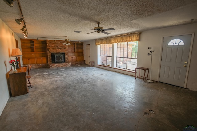 1006 Quitman St, Pittsburg, TX 75686 - unfurnished living room featuring plenty of natural light, a fireplace, ceiling fan, concrete floors, and a textured ceiling