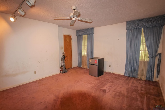 1006 Quitman St, Pittsburg, TX 75686 - carpeted empty room featuring ceiling fan and a textured ceiling