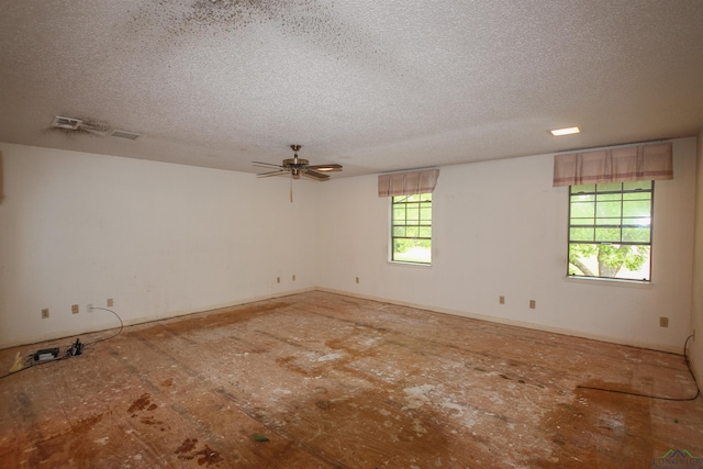 1006 Quitman St, Pittsburg, TX 75686 - empty room featuring a textured ceiling and ceiling fan