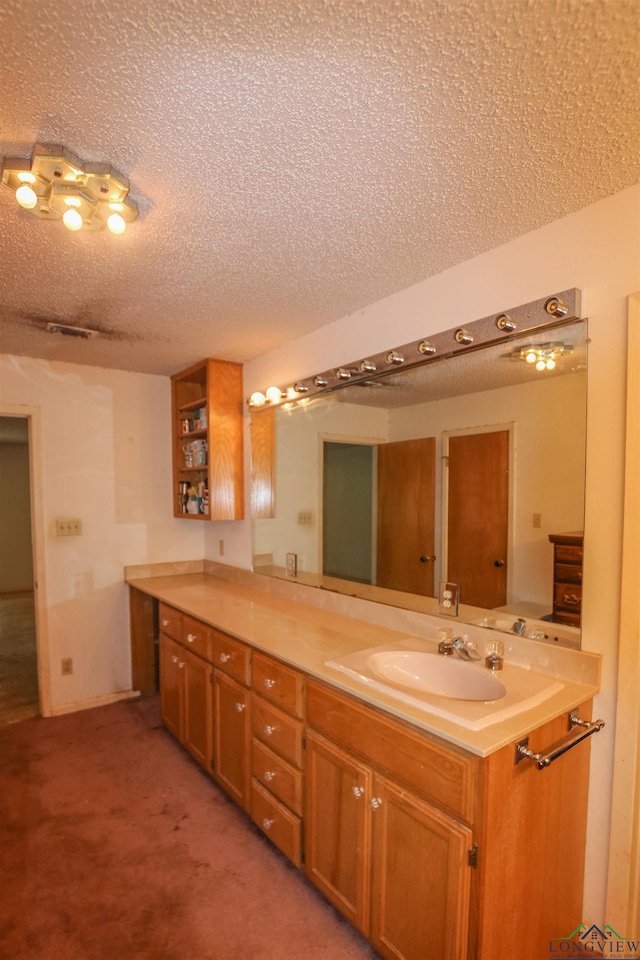 1006 Quitman St, Pittsburg, TX 75686 - bathroom featuring a textured ceiling and vanity