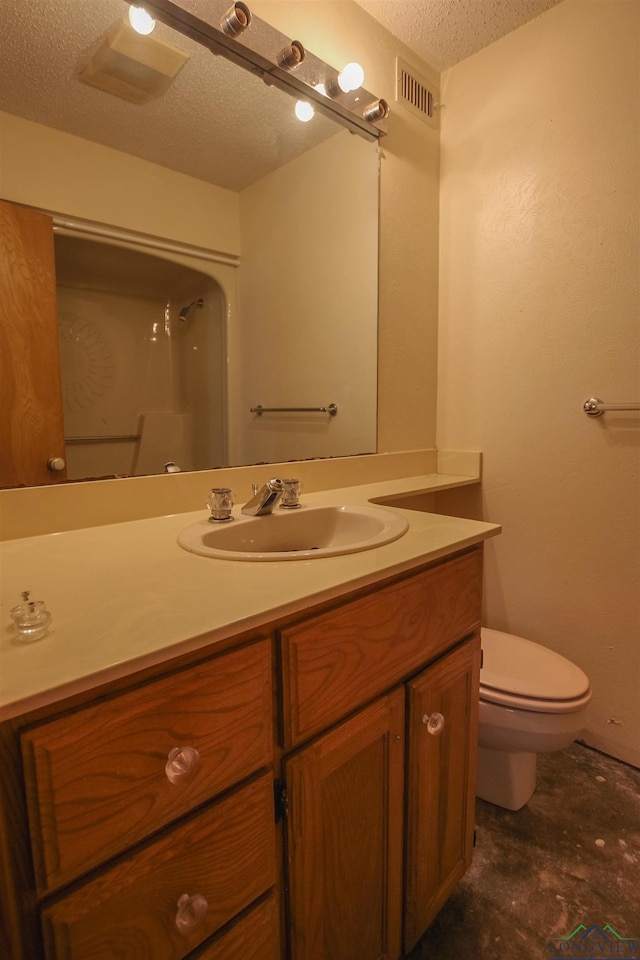 1006 Quitman St, Pittsburg, TX 75686 - bathroom with a textured ceiling, toilet, vanity, and a shower