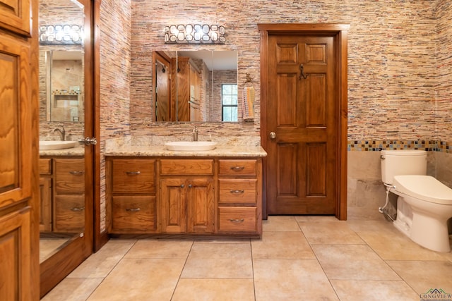 bathroom with tile patterned flooring, vanity, and toilet