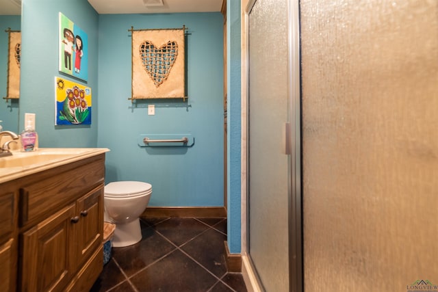 bathroom with tile patterned floors, vanity, toilet, and an enclosed shower