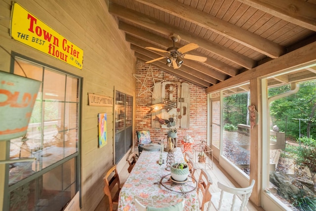 sunroom featuring vaulted ceiling with beams, ceiling fan, and wood ceiling