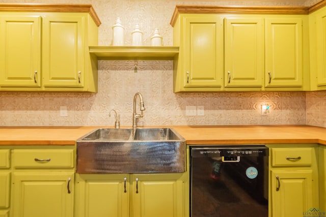 kitchen with tasteful backsplash, wood counters, dishwasher, and sink