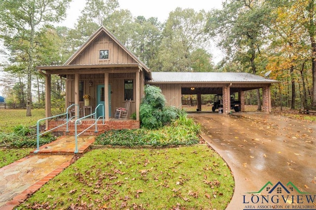 view of front of home with a carport and a porch