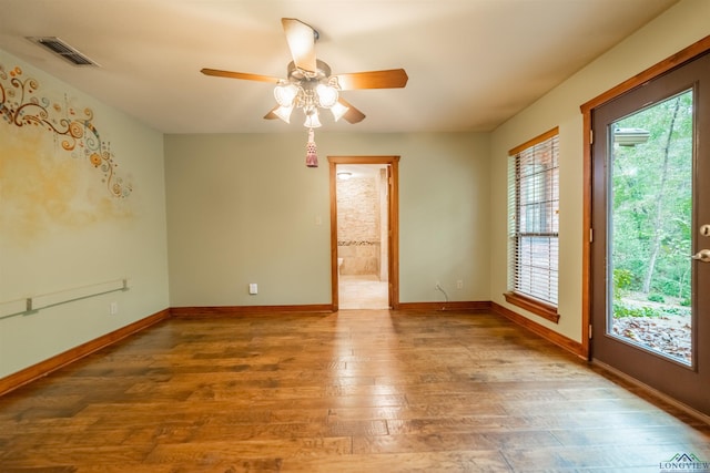 empty room featuring ceiling fan and hardwood / wood-style flooring