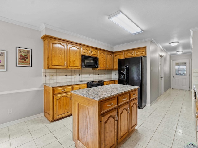 kitchen featuring black appliances, decorative backsplash, ornamental molding, and brown cabinetry