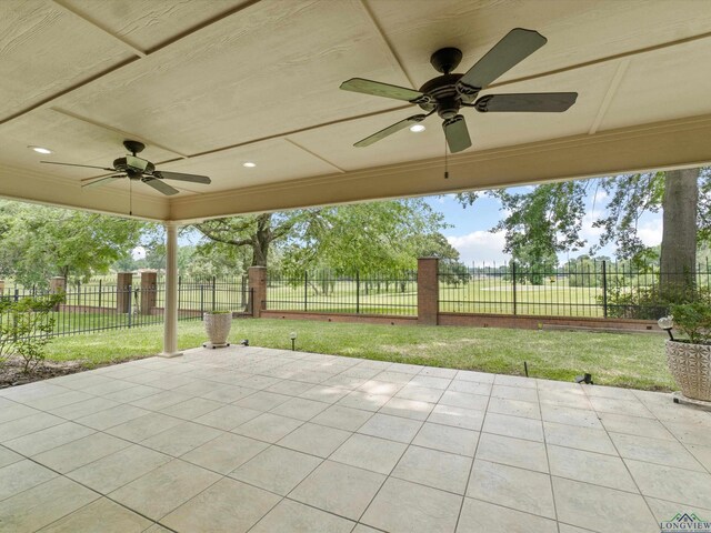 view of patio with fence and a ceiling fan